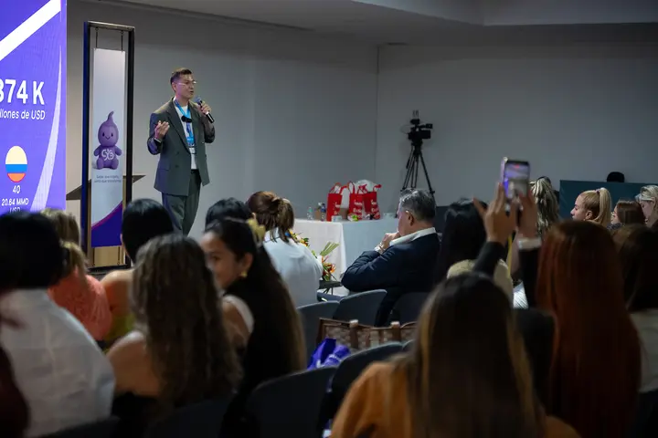 Francisco addresses a full room of attendees.